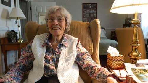 resident Phoebe Berner relaxing on an armchair in homeland