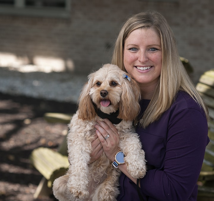 volunteer lisa fetter holding her pet dog ruby
