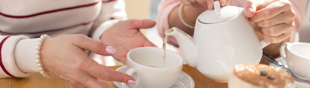 pouring tea for someone using a teapot