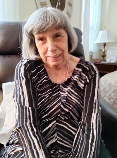 Margie Welby smiling in an armchair