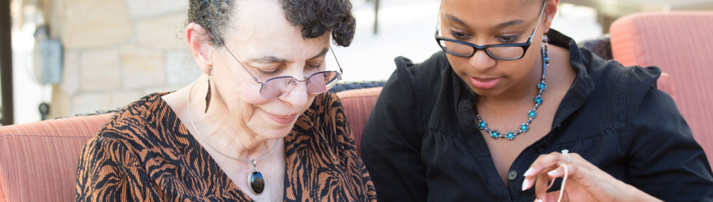 volunteer and resident knitting together