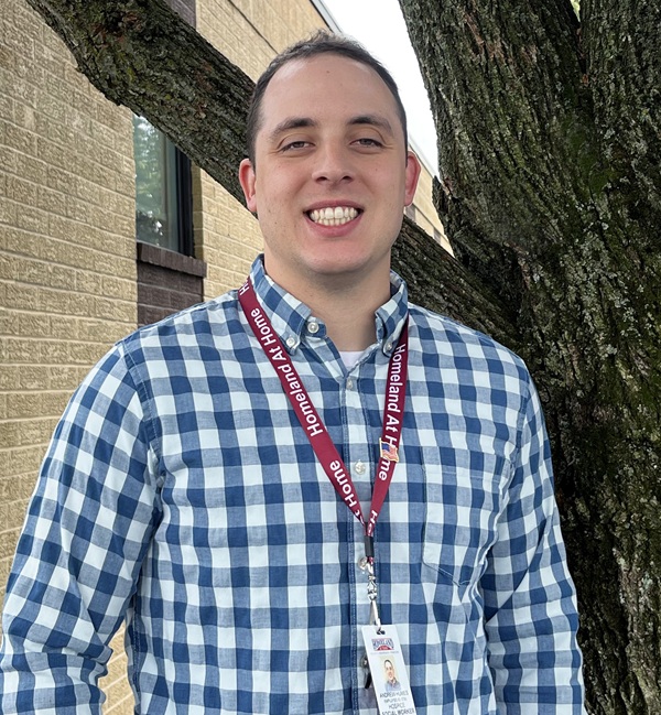 Social Worker Andrew Humes smiling outside of Homeland Center