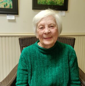 Board of Managers member Babs Phillips in an armchair