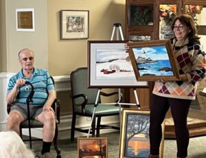 robert zimmerman sitting at a presentation of his art