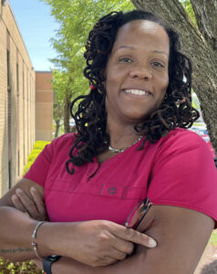 Chastity (Chaz) Anderson Spencer, Homeland CNA, smiling next to a tree