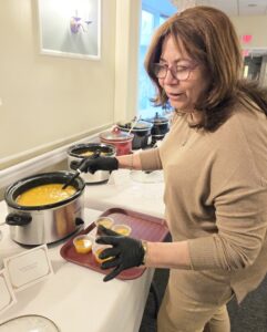 Activities Coordinator Diomaris Pumarol cooking for the souper bowl cookoff