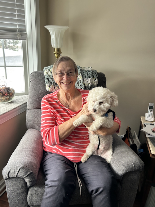 ginny jones smiling and holding her dog