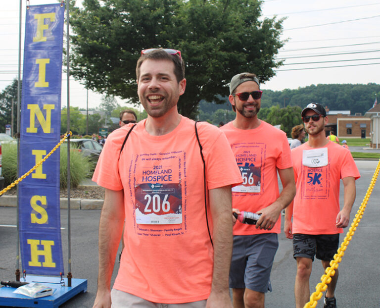 group of smiling runners at the 5k and memorywalk finish line