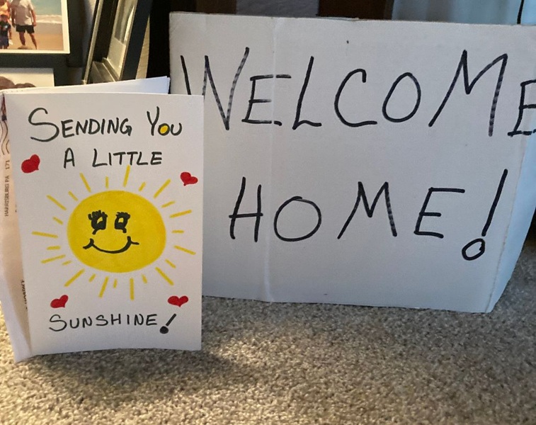 handmade sign and card saying welcome home