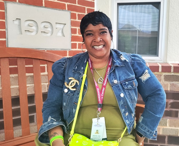 Kristen Tate, receptionist, smiling outside