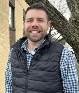 volunteer coordinator ory bower smiling outside of homeland center