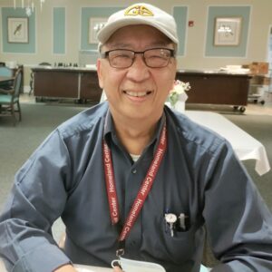 Homeland Chef Manager George Shum smiling in a dining room