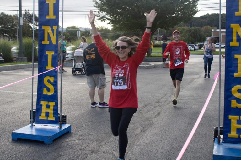 a beaming runner making it past the finish line