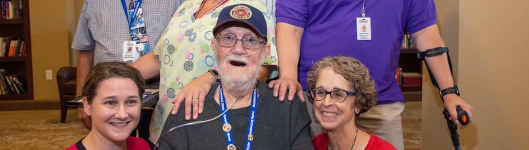 banner of a photo of john keeney surrounded by friends and staff