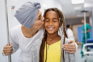 palliative patient kissing a child on the cheek