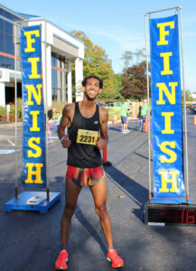 Bryce Hampton smiling at the finish line, where he was first to cross in 2025