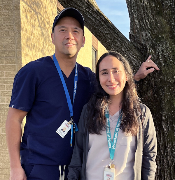 homeland volunteers maryann and jules canete outside next to a tree